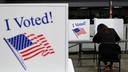 Polling place tables topped with privacy screens reading "I Voted!" 