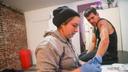 Volunteer Jen Shinefeld cleans a wound on the arm of Nick Gallagher at an outreach organization based in Philadelphia.