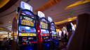 A slot machine is pictured on the floor of a casino.