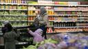 Ai'Yana Mu'Min, of West Philly, shops inside the Golden Farms supermarket with children.