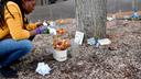 A woman cleans up the Black Lives Matter memorial at the Dr. Martin Luther King Jr. Plaza in downtown State College.