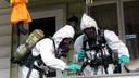 Members of the Pennsylvania State Police Clandestine Lab Response Team remove chemicals from the front porch of a home in Minersville in 2013.