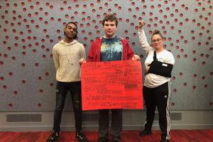 From left, Marshall Everett, Ed Peters, and Sabrina Herb protest the cuts to campus mental health services at HACC, Central Pennsylvania's Community College, on Oct. 23, 2019.