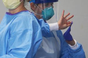 Groups that represent the state’s nursing and long-term care centers say workers need protective equipment like masks, as seen here on a medical worker in Philadelphia.