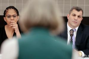 Pennsylvania lawmakers Morgan Cephas (left) and Mark Rozzi (right) listen to a speaker in Philadelphia.