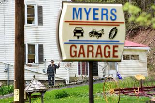 John Myers, whose son shot at BLM activists in August, stands outside his home and garage.